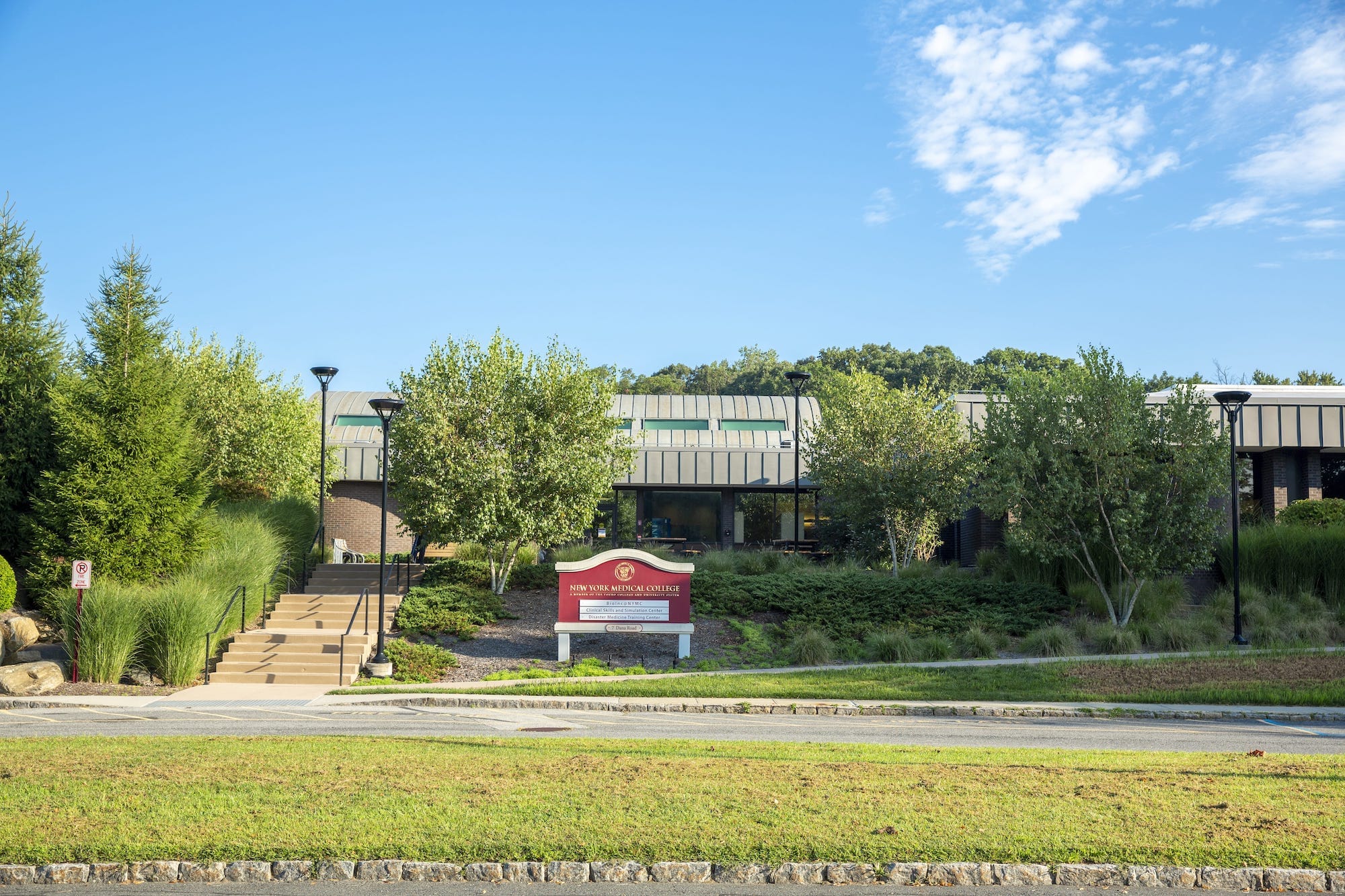 7 dana road - a postwar modernist building on a road with grass and trees