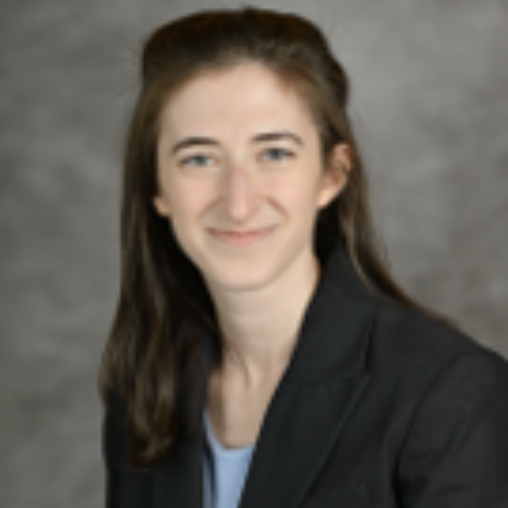 woman with long dark hair wearing dark blazer