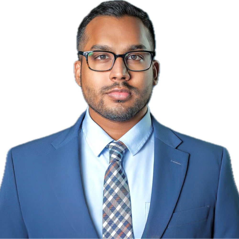 man with dark hair wearing glasses and blue suit