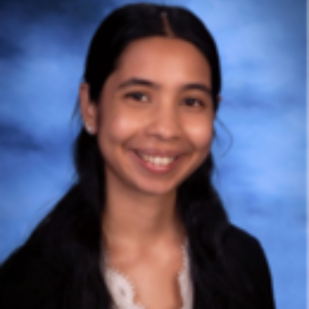 woman with long dark hair in front of blue background