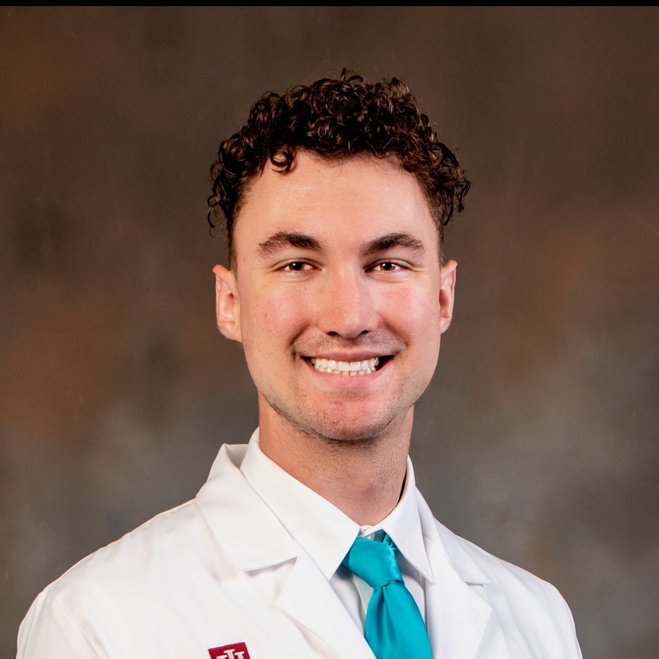 male resident standing in front of gray background