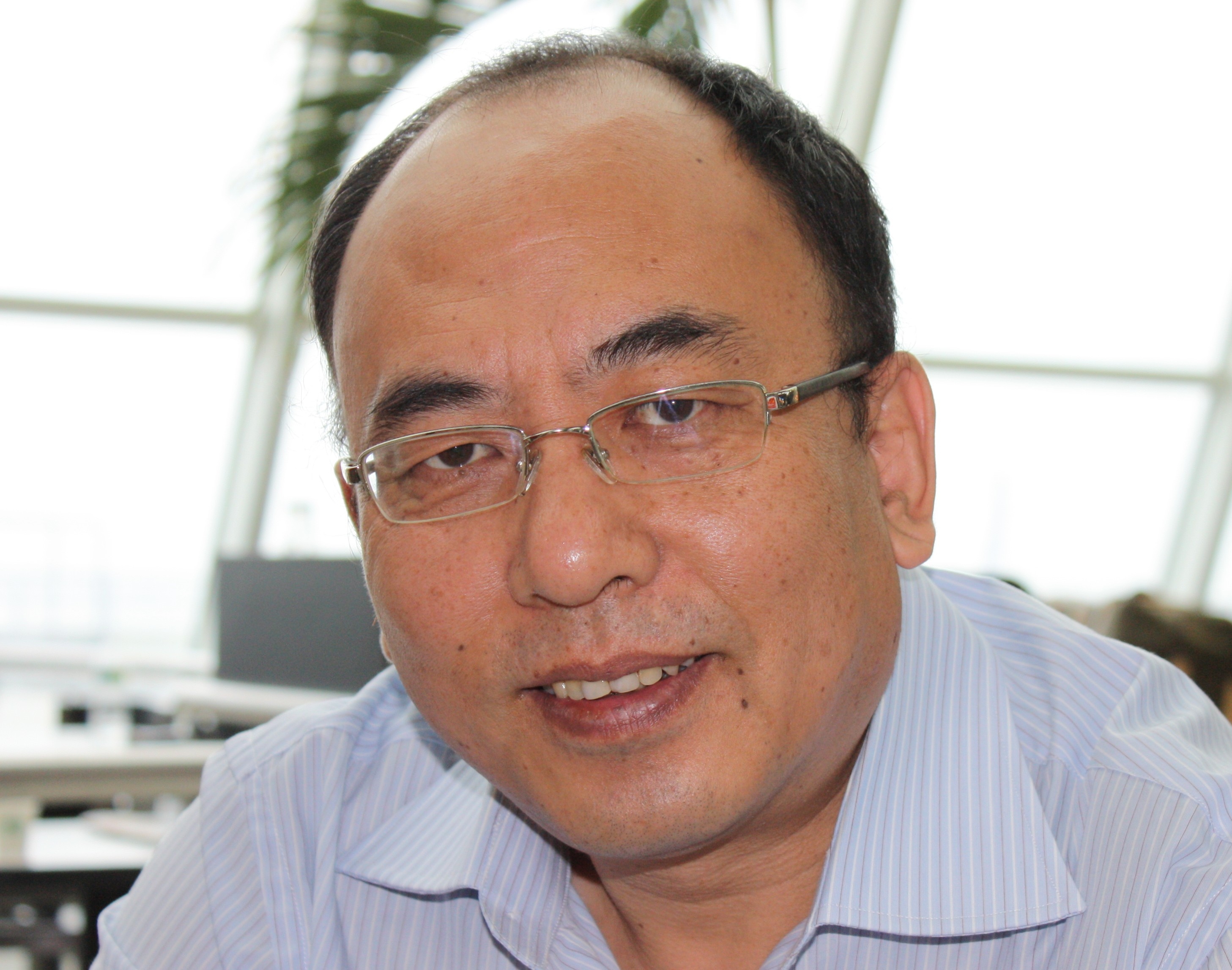 man wearing glasses and light colored shirt