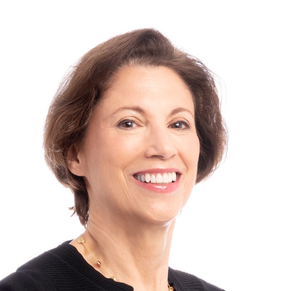 woman with short brown hair in front of white background