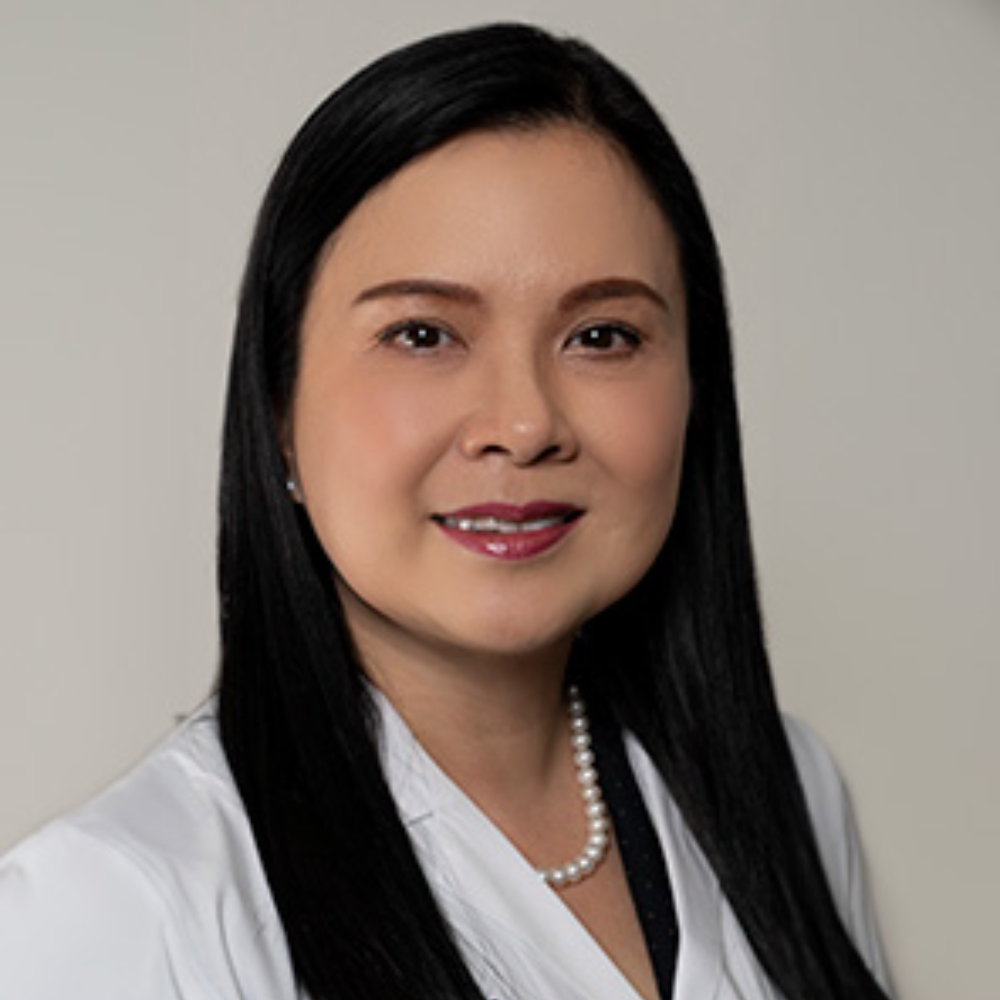 asian woman with long dark hair wearing white blouse