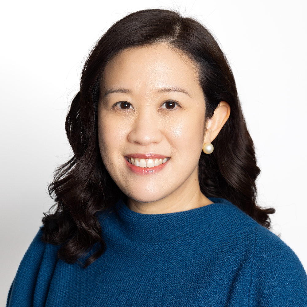 Asian woman with dark hair wearing blue top