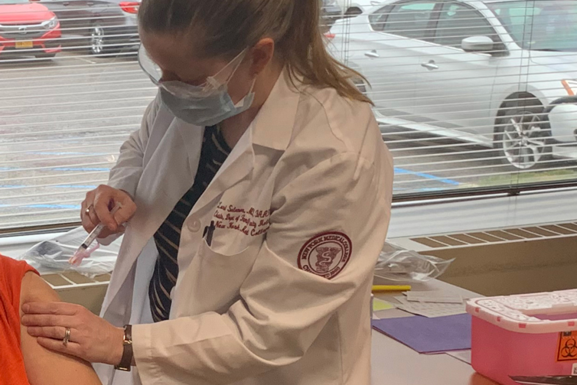 NYMC staff member administering COVID vaccine