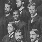 Alonzo Potter Burgess Holley. He is the only Black man in a group of white men. All are wearing identical suits, and look accomplished.