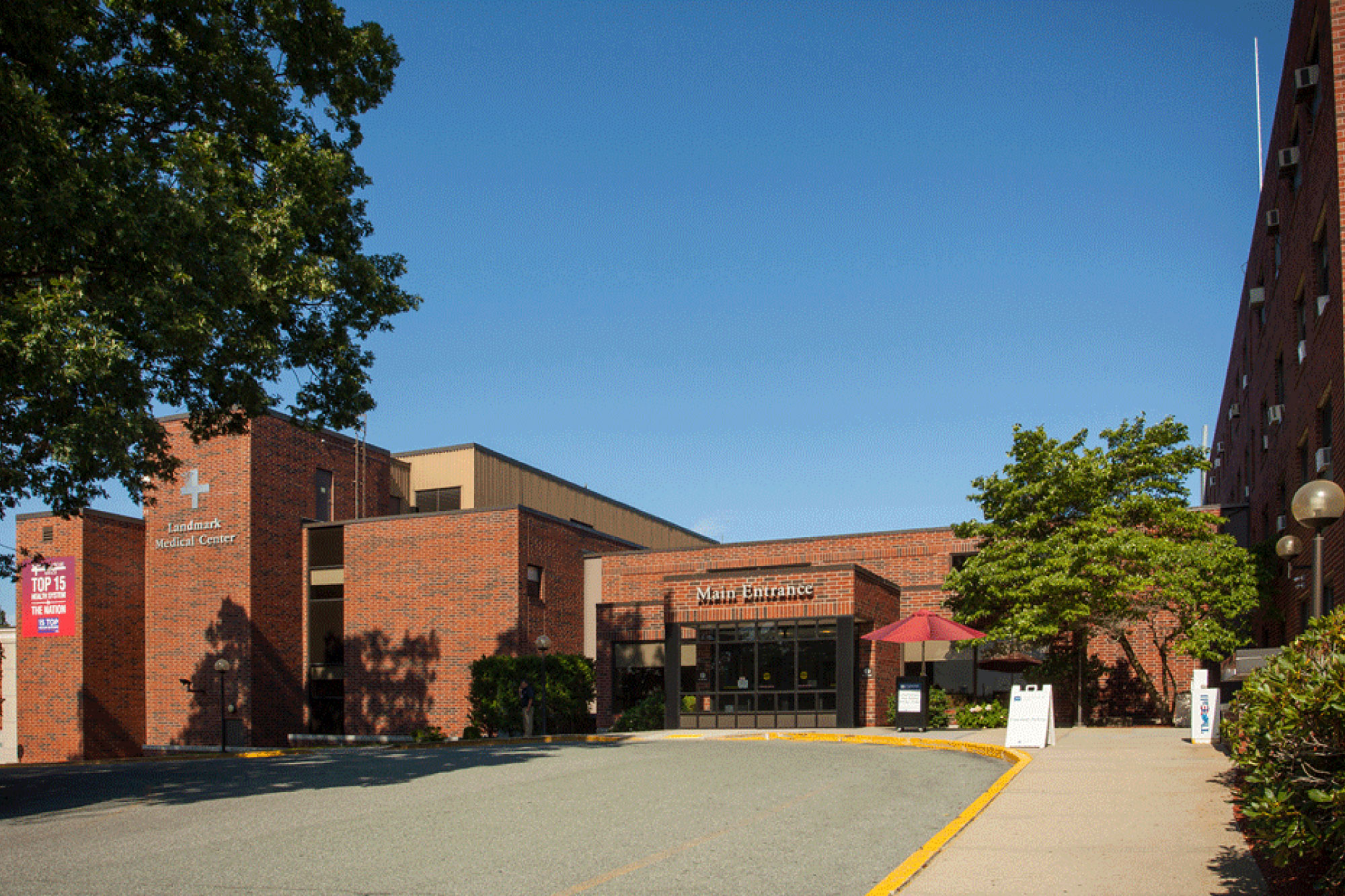 Main entrance of Landmark medical center. Multi-story building with red brick exterior