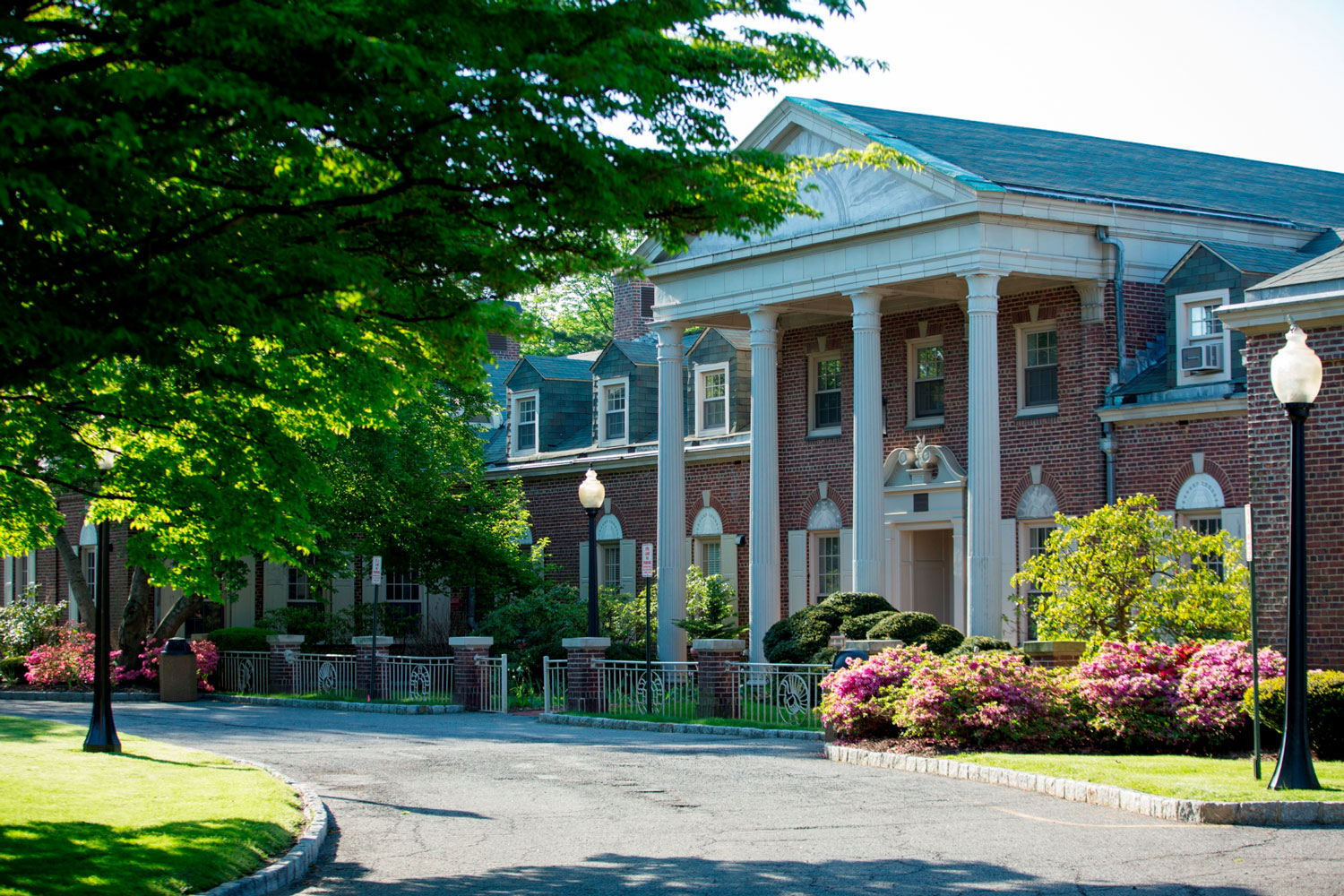 NYMC building on campus with flowers in front