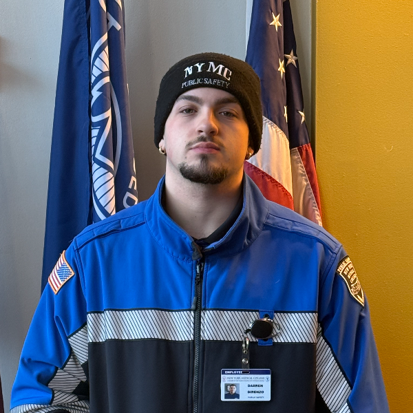 Man in blue and black jacket with black beanie