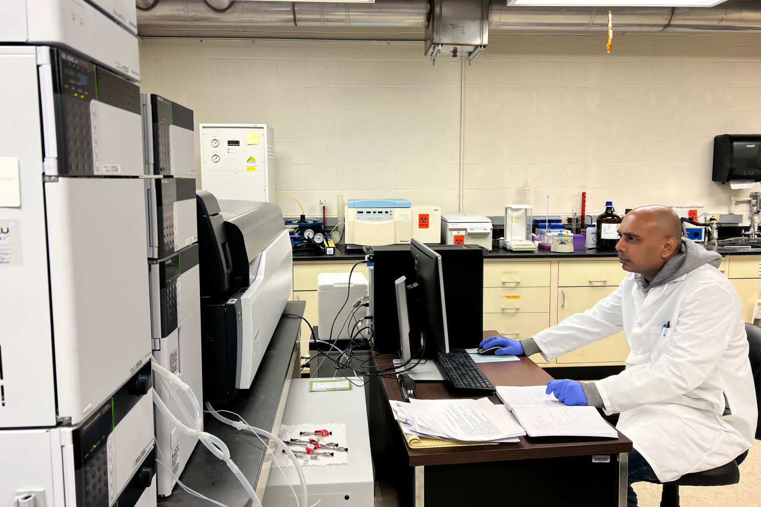 Researcher working on computer in lab