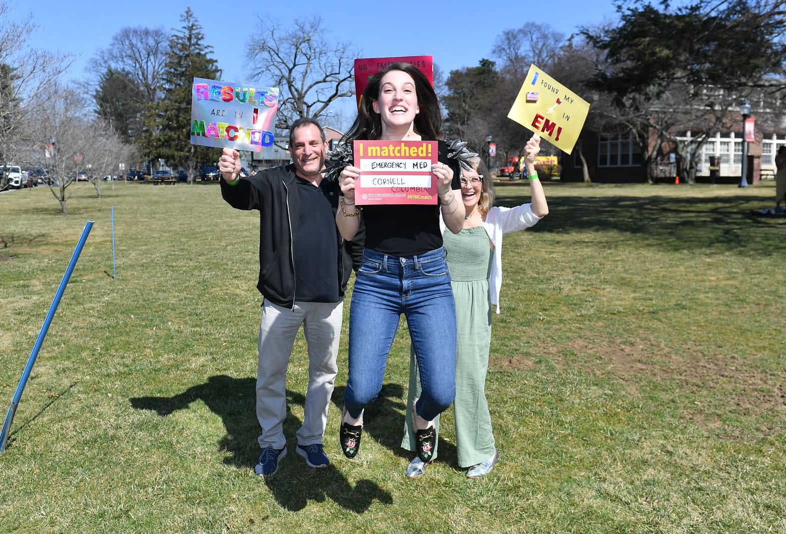 excited nymc student holding up sign - 