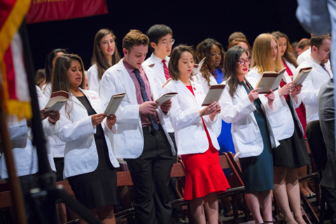 White Coat Graduates Reading