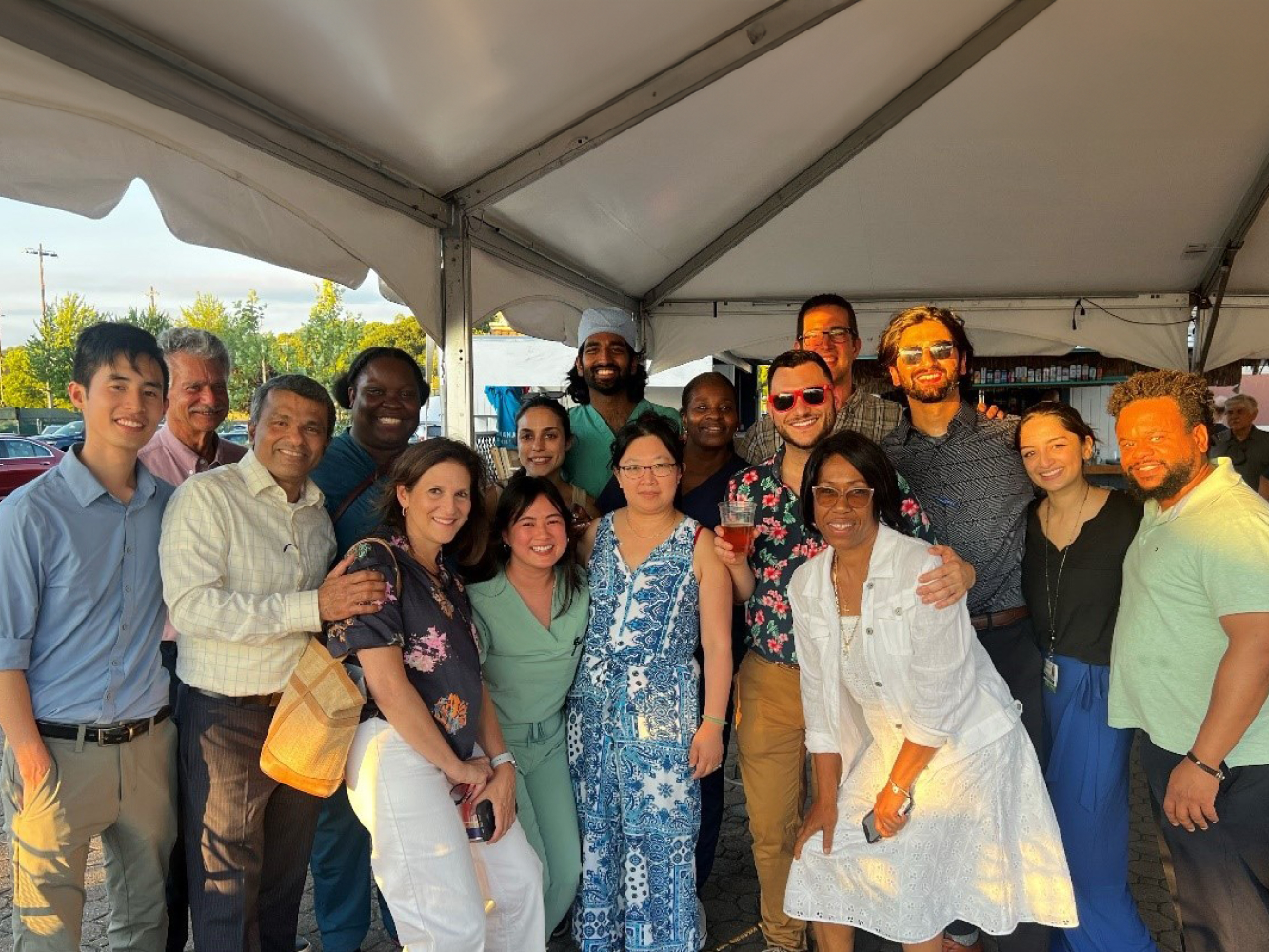 Residents smiling at outdoor happy hour wellness event