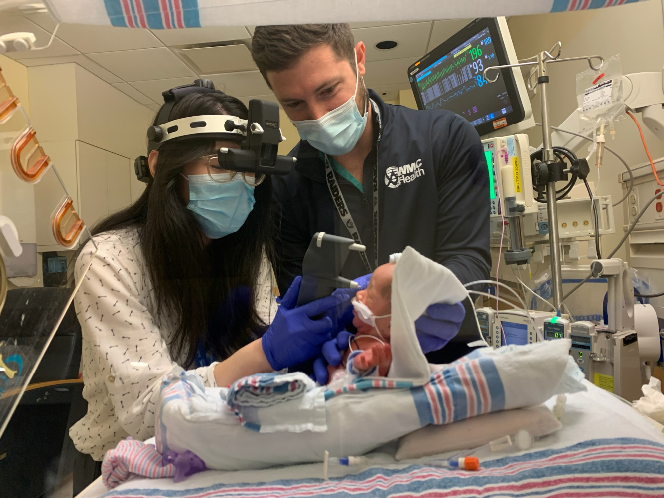 Residents examine a neonate in Maria Ferari Children’s Hospital ICU