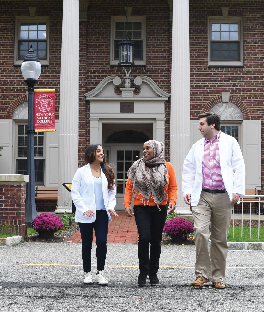 Three NYMC students walking on campus