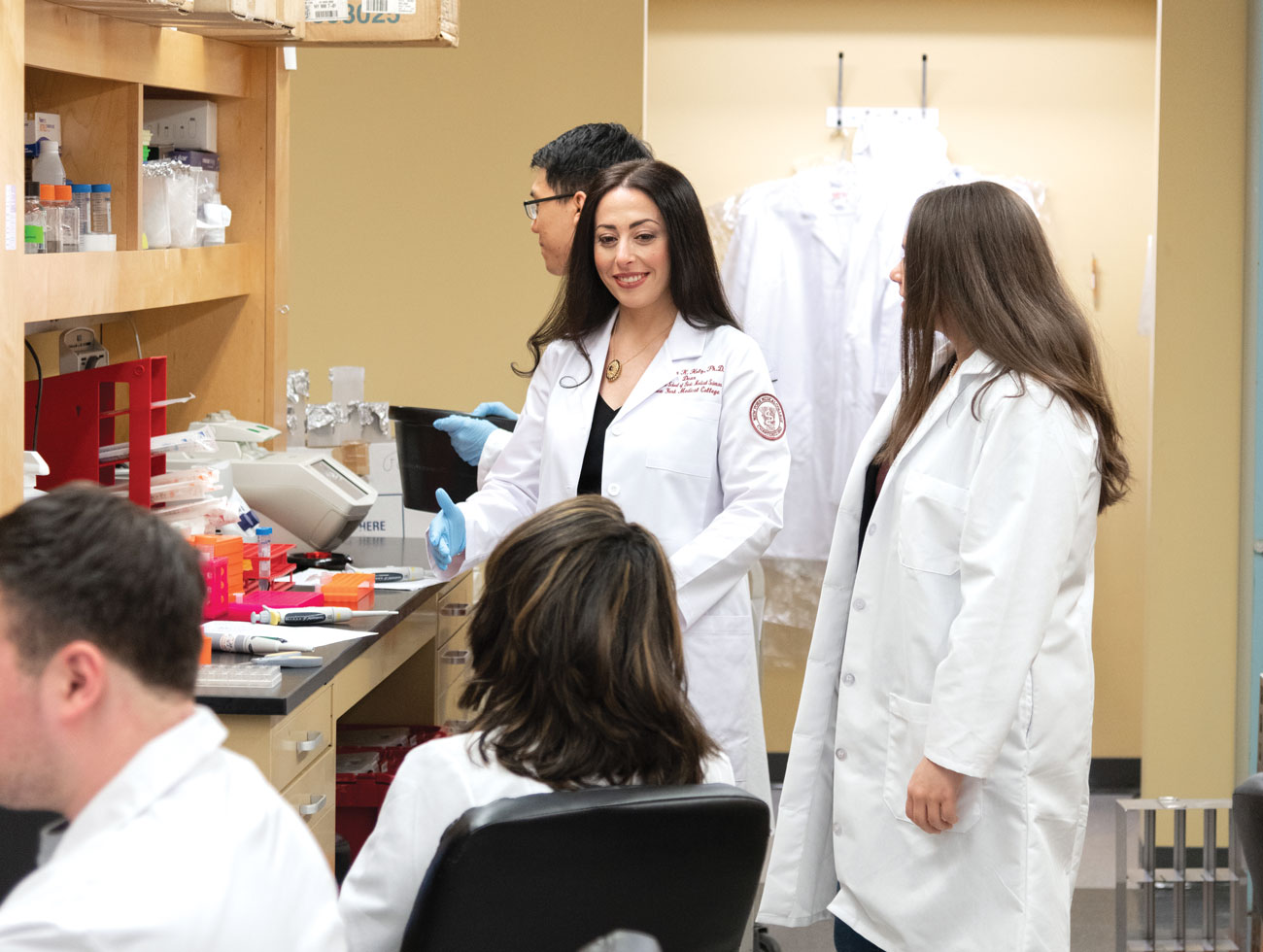 Students and professor conducting research in lab