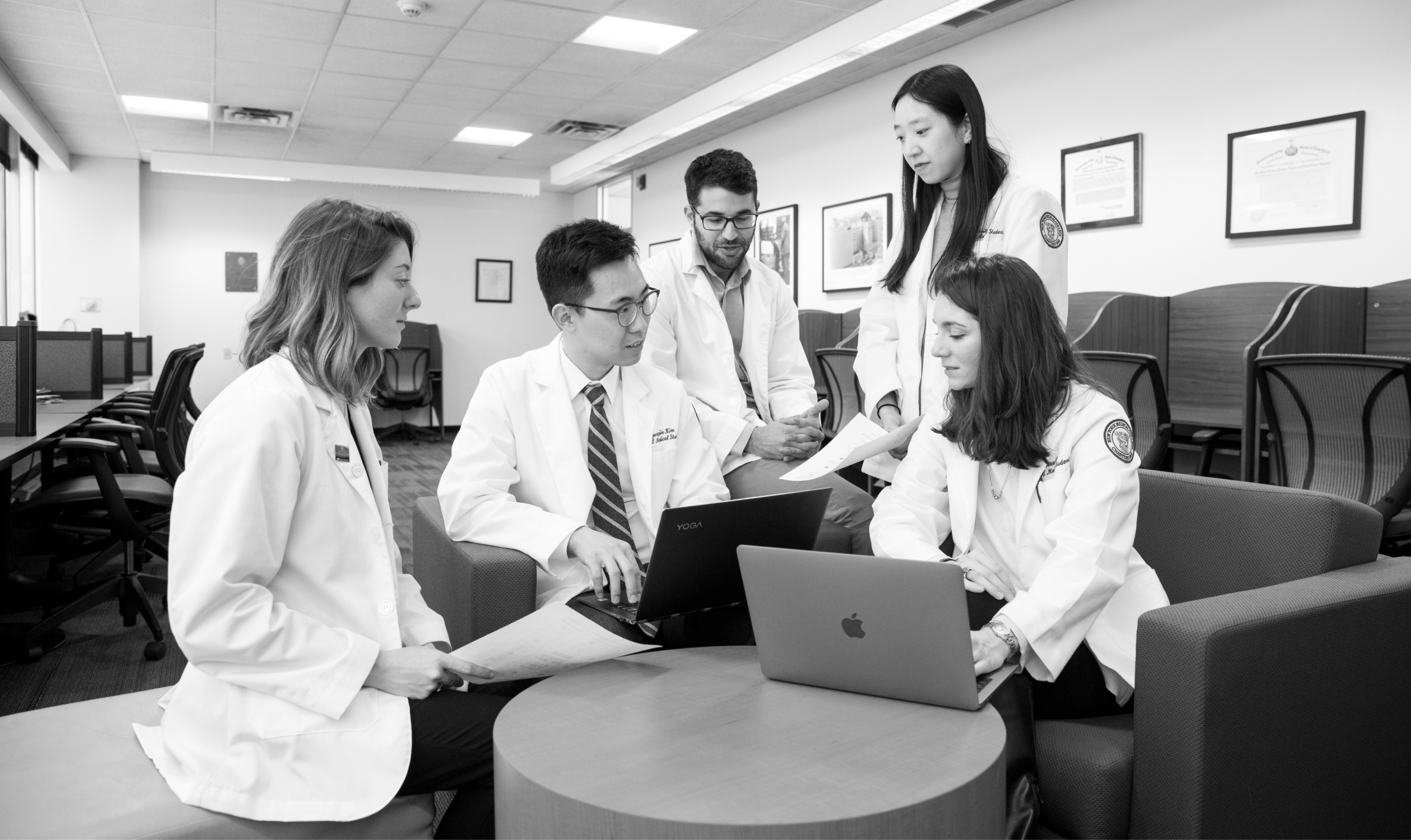 nymc medical students gathered around a laptop